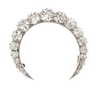 * An Edwardian Platinum Topped Gold and Diamond Crescent Brooch, 8.50 dwts.