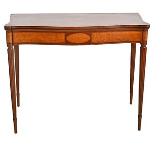 Sheraton Mahogany Game Table
having serpentine top over conforming frieze with light burlwood panel inlays, all set on turned and fluted legs
circa 18