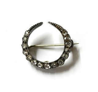 A silver and gold, diamond crescent brooch,