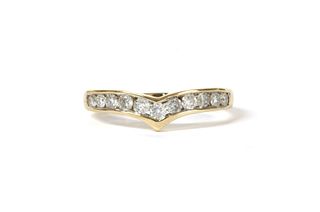 A gold diamond wishbone-shaped half eternity ring,