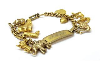 A gold filled identity bracelet with gold charms,