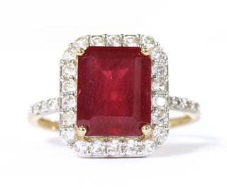 A 9ct gold fracture filled ruby and zircon halo cluster ring,