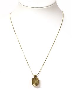 A gold citrine pendant,