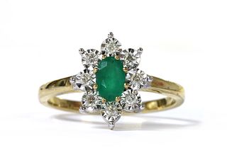 A gold emerald and diamond cluster ring,