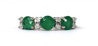 A gold eleven stone emerald and diamond ring,