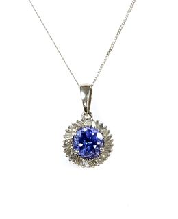 A white gold tanzanite and diamond cluster pendant,
