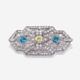 A yellow diamond, diamond, zircon, and fourteen karat white gold pendant/brooch, Raymond Yard