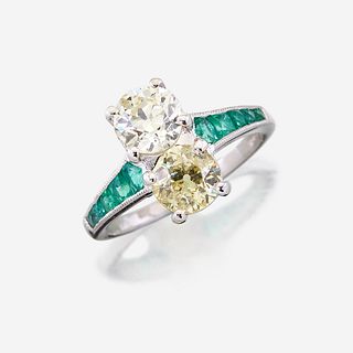 A fancy yellow diamond, diamond, emerald, and platinum ring