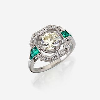 A diamond, emerald, and platinum ring