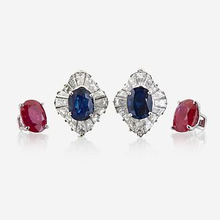 A pair of diamond and platinum earring jackets with interchangeable ruby and sapphire studs