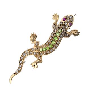 An early 20th century gold and gem-set salamander brooch. The split pearl lizard, with circular-shap