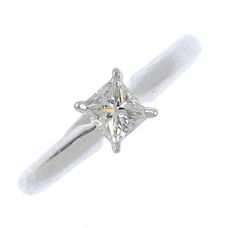 A diamond single-stone ring. The rectangular-shape diamond, weighing 0.33ct, to the plain band. Diam
