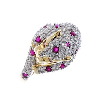 A 9ct gold ruby and diamond leopard ring. Set with circular-shape rubies and single-cut diamonds, to