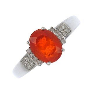 An 18ct gold fire opal and diamond dress ring. The oval-shape fire opal, to the single-cut diamond s