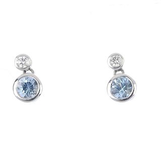 A pair of 18ct gold aquamarine and diamond earrings. Each designed as a circular-shape aquamarine co