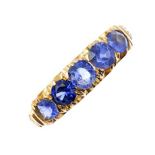 An early 20th century 18ct gold gem-set five-stone ring. The graduated circular-shape sapphire and b