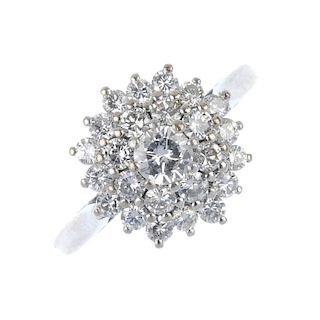 A diamond cluster ring. The brilliant-cut diamond, within a similarly-cut diamond, stepped double su