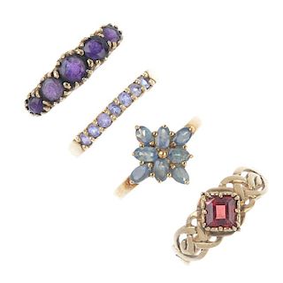 A selection of four 9ct gold gem-set rings. To include an amethyst five-stone ring, a garnet single-