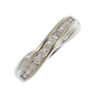 A 9ct gold diamond crossover band ring. The brilliant-cut diamond crossover line, to the tapered ban