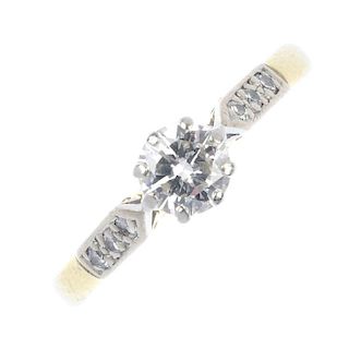 An 18ct gold diamond single-stone ring. The brilliant-cut diamond, to the similarly-cut diamond line