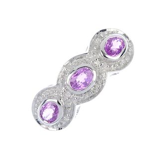 A 9ct gold sapphire and diamond triple cluster ring. The oval-shape pink sapphire and single-cut dia