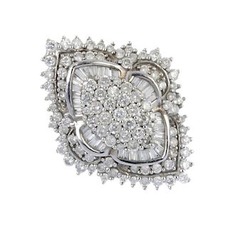 A diamond dress ring. The pave-set diamond marquise-shape panel, within a series of baguette and bri