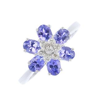 A 9ct gold diamond and tanzanite floral cluster ring. The single-cut diamond cluster, within a circu