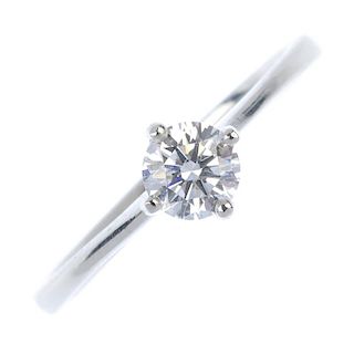 A platinum diamond single-stone ring. The brilliant-cut diamond, weighing 0.50ct, to the tapered sho