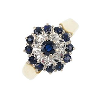 An 18ct gold sapphire and diamond cluster ring. The circular-shape sapphire, raised to the single-cu