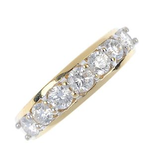 An 18ct gold diamond seven-stone ring. The slightly graduated brilliant-cut diamond line, to the tap