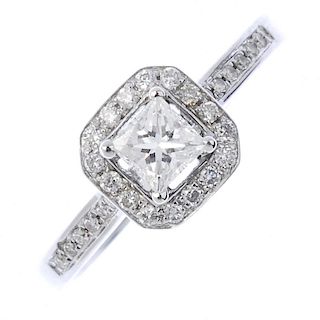 An 18ct gold diamond cluster ring. The square-shape diamond, within a brilliant-cut diamond halo, to