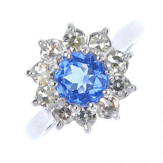 An 18ct gold paste and diamond cluster ring. The circular-shape blue paste, within a single-cut diam