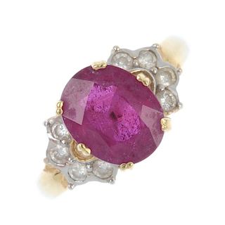 An 18ct gold glass-filled ruby and diamond dress ring. The oval-shape glass-filled ruby, to the bril