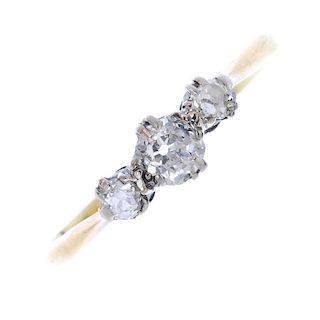 A diamond three-stone ring. The old-cut diamond line, to the tapered shoulders and plain band. Estim