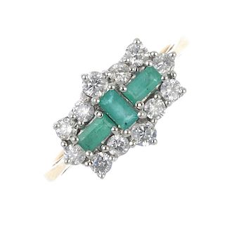 An 18ct gold emerald and diamond cluster ring. The rectangular-shape emerald line, within a brillian