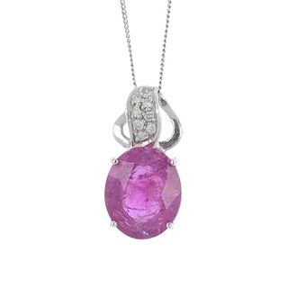 An 18ct gold ruby and diamond pendant. The oval-shape ruby, to the brilliant-cut diamond scrolling s