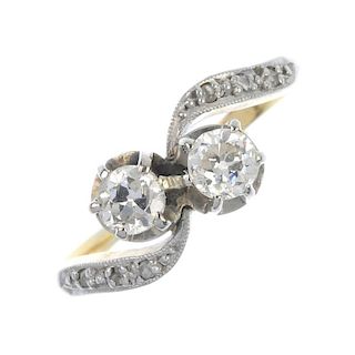 A diamond crossover ring. The twin illusion-set old-cut diamonds, with diamond point asymmetric shou