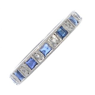 A sapphire and diamond full-circle eternity ring. Designed as an alternating square-shape sapphire a