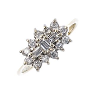 An 18ct gold diamond cluster ring. The baguette-cut diamond line, within a brilliant-cut diamond sur