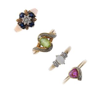 A selection of four diamond and gem-set rings. To include an oval-shape peridot and diamond crossove