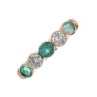 An emerald and diamond five-stone ring. The alternating circular-shape emerald and brilliant-cut dia