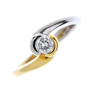 An 18ct gold diamond single-stone ring. Of bi-colour design, the brilliant-cut diamond, within a par