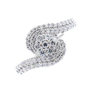 A diamond dress ring. The brilliant-cut diamond cluster, with similarly-cut diamond asymmetric shoul