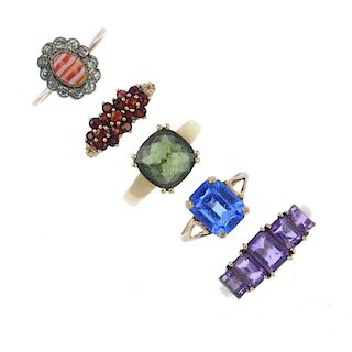 A selection of five gem and paste-set rings. To include a 9ct gold amethyst five-stone ring, a 9ct g