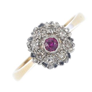 An 18ct gold ruby and diamond cluster ring. The circular-shape ruby, within a single-cut diamond sca