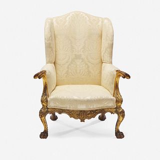 A Chippendale style carved and gilt open arm chair