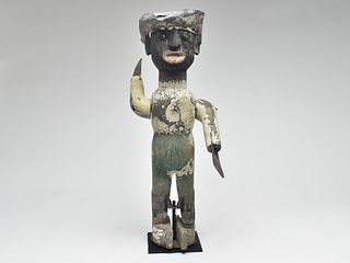 Metal and carved wood Whirligig with hat and applied facial features.