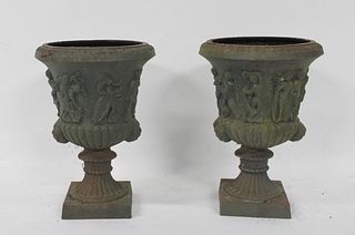 An Ornate Pair of Patinated Cast Iron Urns.