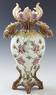 Large Eichwald Art Nouveau Majolica Vase, c. 1880, #735, with a scalloped floral decorated rim over double leaf form handles, to floral and leaf relie