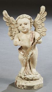 Florentine Style Carved Wood Putto, 19th c., holding a guitar, on an integral stepped octagonal base, with traces of original gilt, H.- 16 in., W.- 9 